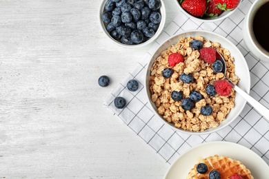 Photo of Tasty breakfast served on white wooden table, flat lay. Space for text