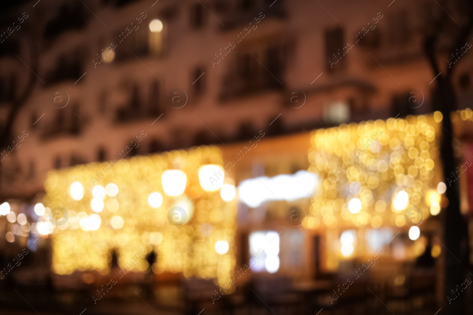 Photo of Blurred view of building with beautiful street lights at night. Bokeh effect