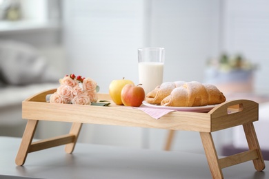 Photo of Tray with delicious croissants, milk and apples on table