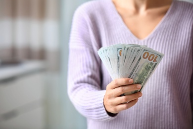 Photo of Woman with American money at home, closeup