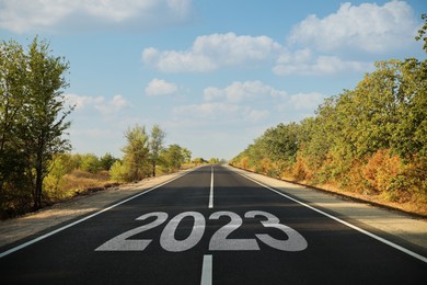 Image of Start of new 2023 year. Asphalt road with numbers on sunny day