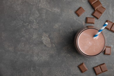 Photo of Delicious chocolate milk on grey table, flat lay. Space for text