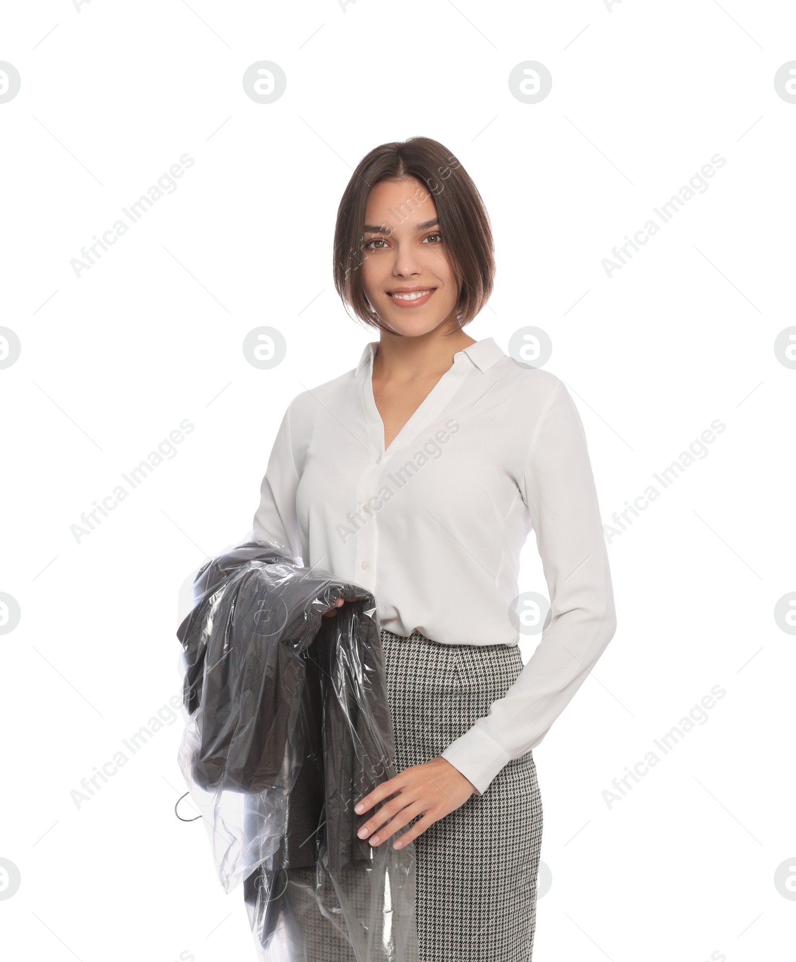 Photo of Woman holding garment cover with clothes on white background. Dry-cleaning service