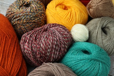 Photo of Many different soft woolen yarns as background, closeup