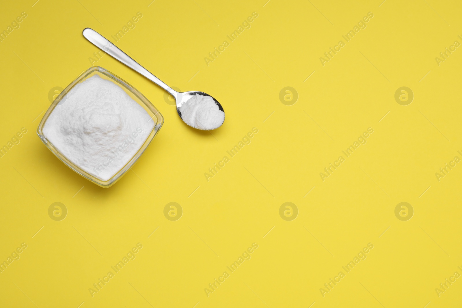 Photo of Sweet powdered fructose on yellow background, flat lay. Space for text