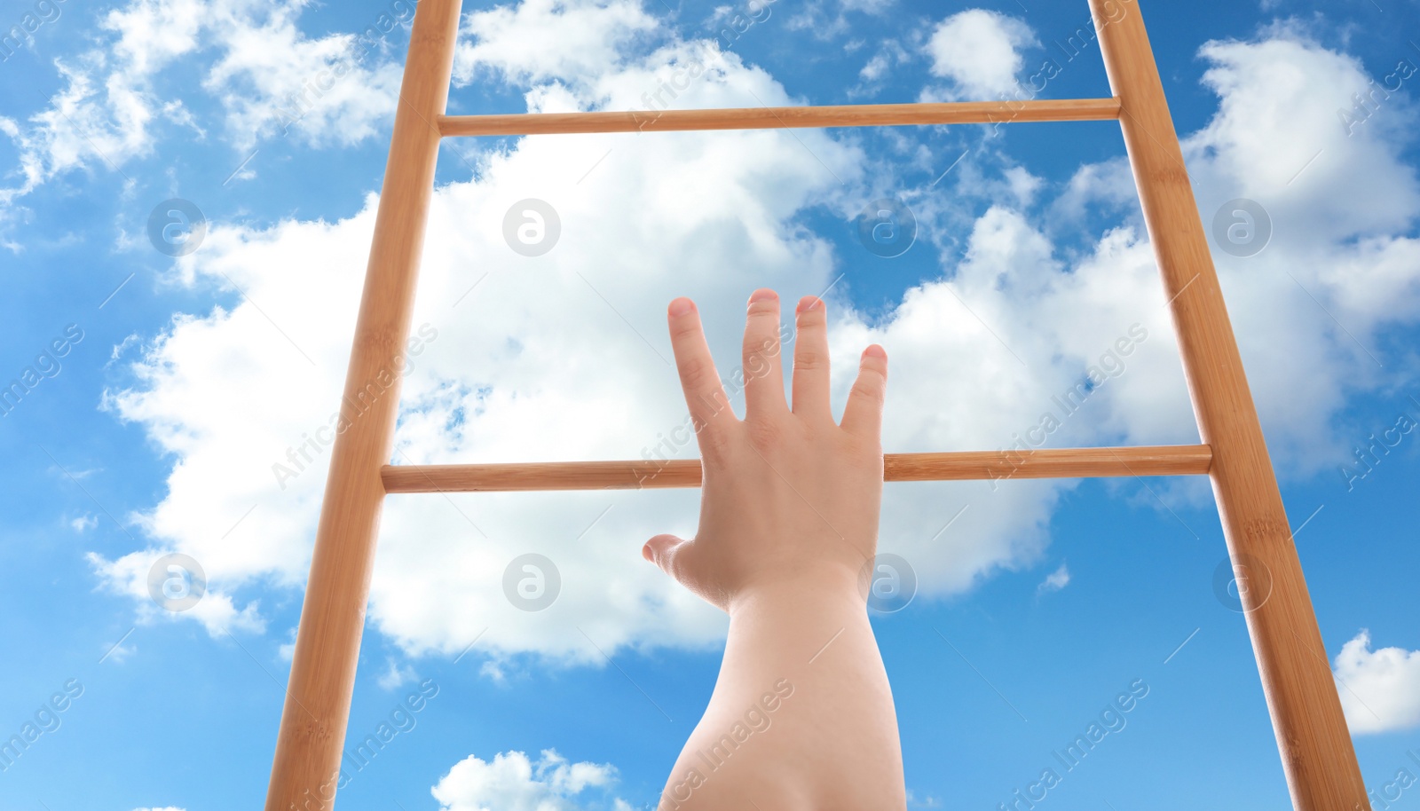 Image of Woman climbing up wooden ladder against blue sky with clouds, closeup. Banner design 