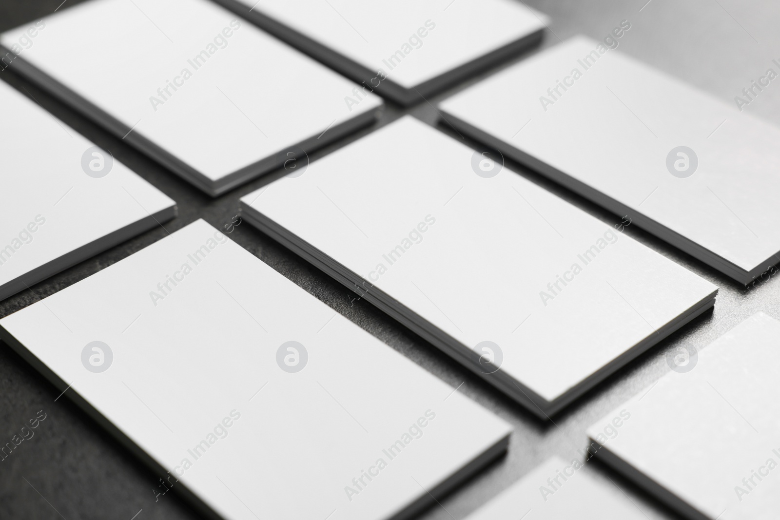 Photo of Blank business cards on grey textured table, closeup. Mockup for design