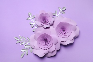 Beautiful flowers and branches made of paper on violet background, flat lay