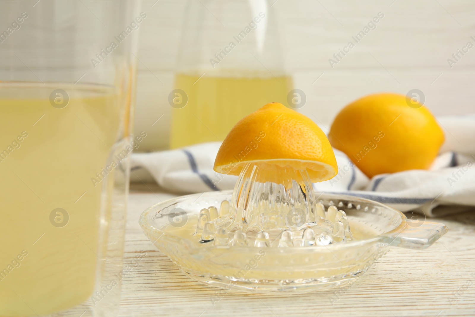 Photo of Freshly squeezed lemon juice on white wooden table