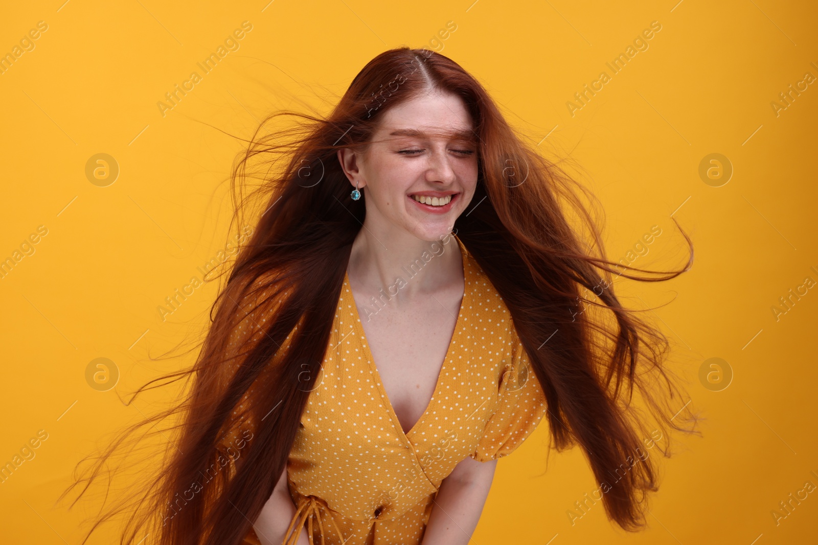 Photo of Portrait of smiling woman on yellow background