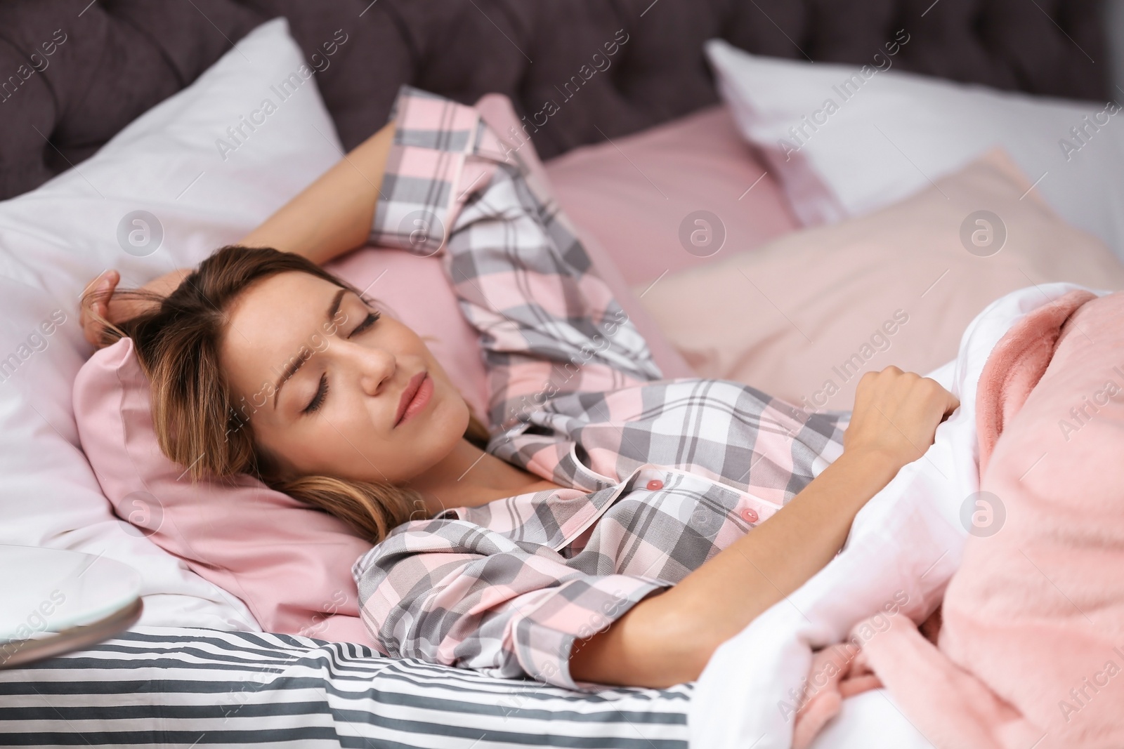 Photo of Young beautiful woman sleeping in bed at home. Early morning