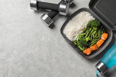 Photo of Flat lay composition with container of natural protein food on gray background