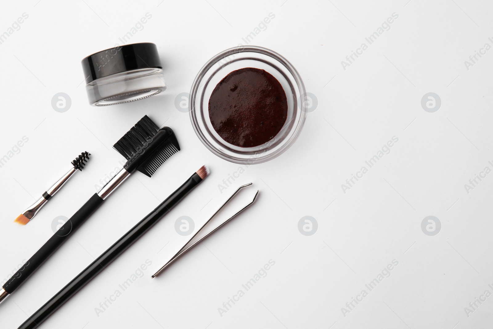 Photo of Flat lay composition with eyebrow henna and professional tools on white background, space for text