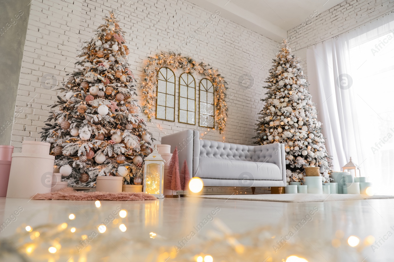 Photo of Beautiful interior of living room with decorated Christmas trees