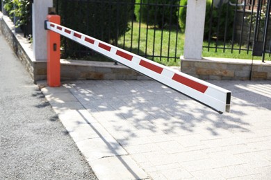Photo of Closed boom barrier in city on sunny day