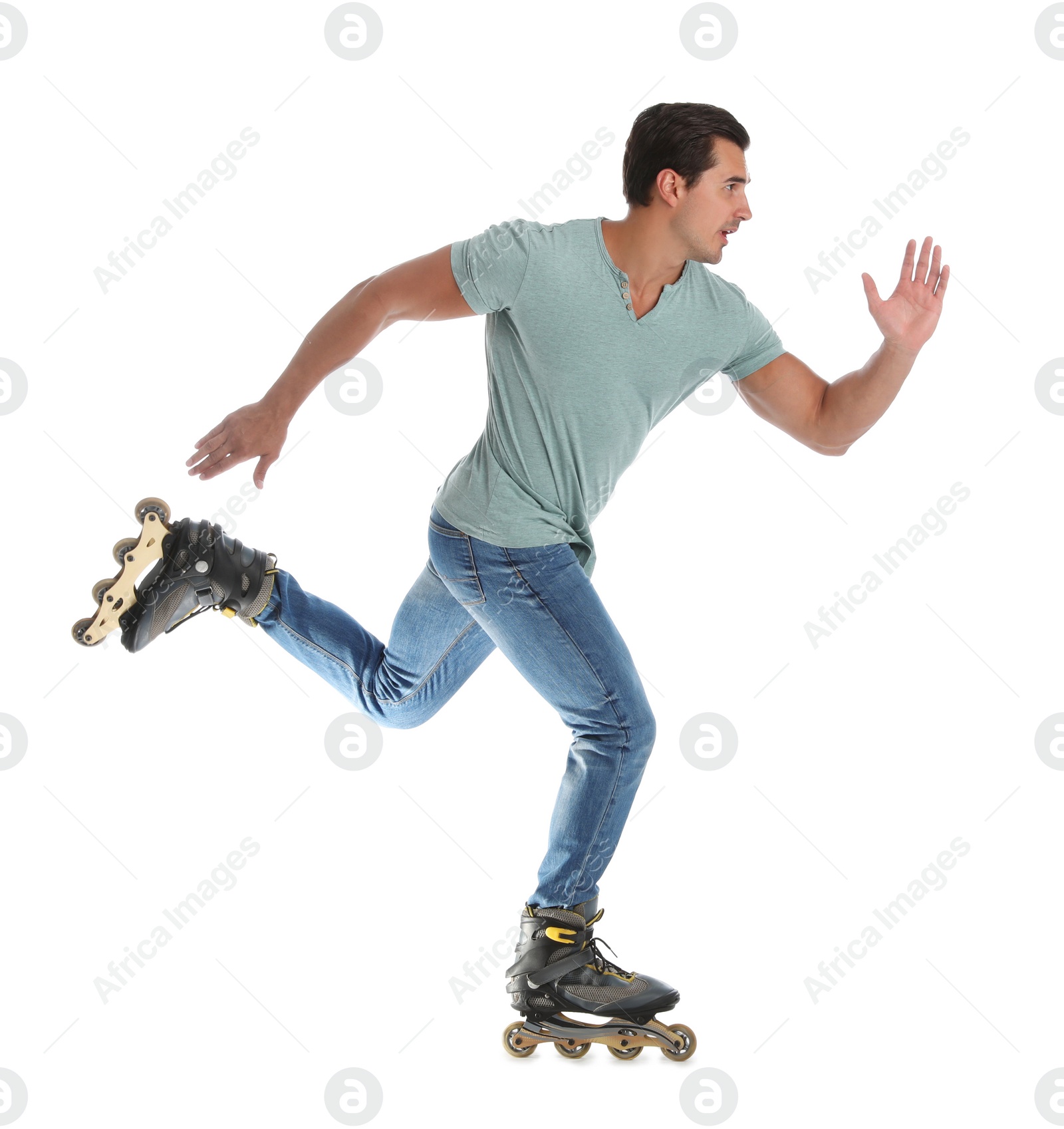 Photo of Handsome young man with inline roller skates on white background