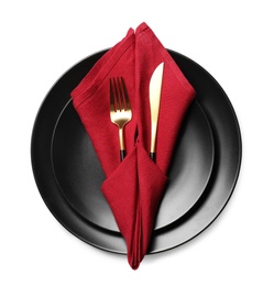 Beautiful table setting with golden cutlery and red napkin on white background, top view