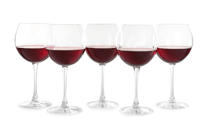 Photo of Glasses with red wine on white background