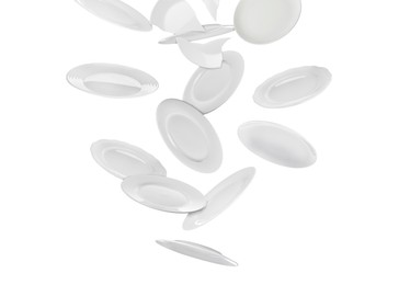 Image of Many ceramic plates falling on white background