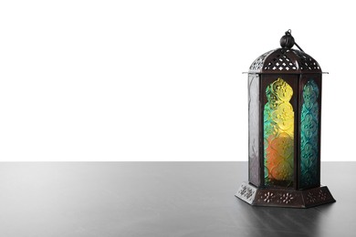 Photo of Decorative Arabic lantern on grey table against white background