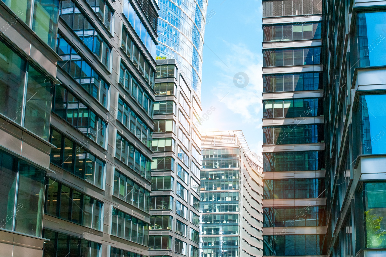 Photo of Stylish buildings with many windows under cloudy sky