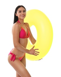 Beautiful young woman in stylish bikini with inflatable ring on white background