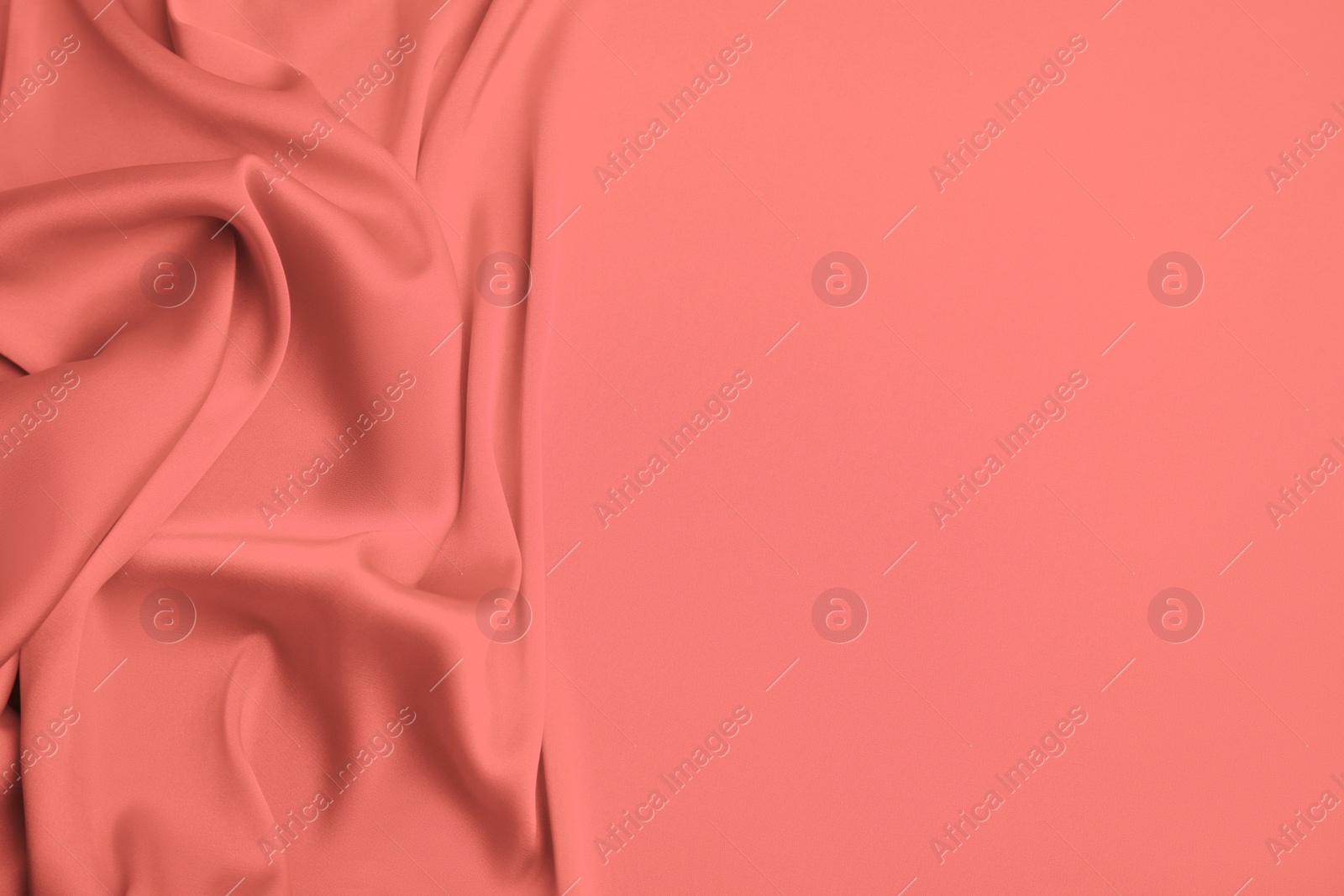 Image of Delicate coral silk fabric as background, top view. Space for text