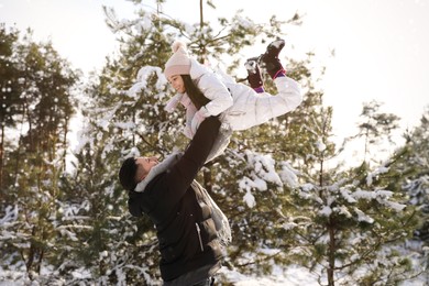 Photo of Happy father and daughter playing outdoors on winter day. Christmas vacation