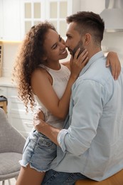 Lovely couple enjoying time together in kitchen