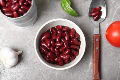 Photo of Flat lay composition with canned beans on grey background