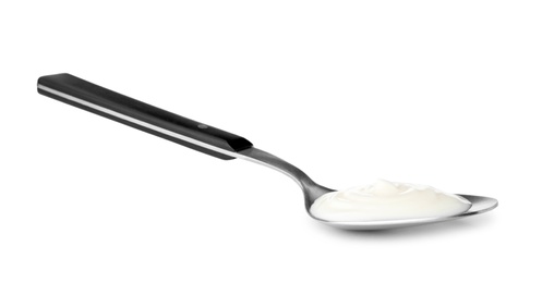 Photo of Metal spoon with sour cream on white background