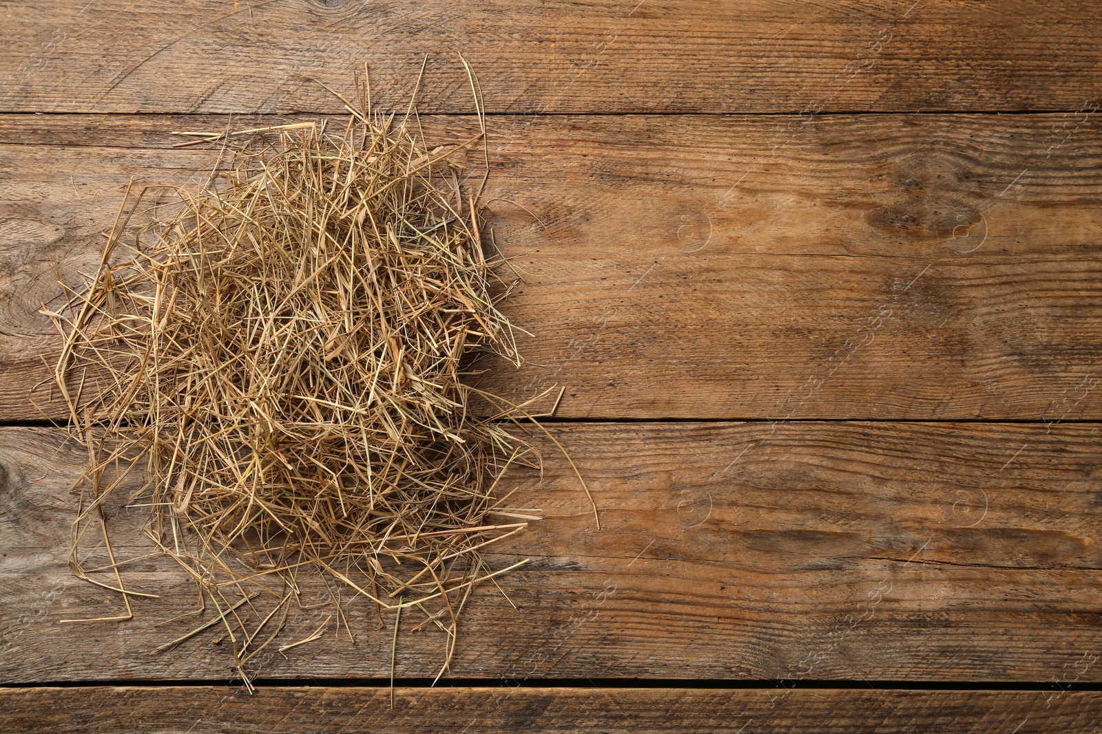 Photo of Dried hay on wooden background, top view. Space for text