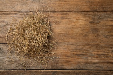 Photo of Dried hay on wooden background, top view. Space for text