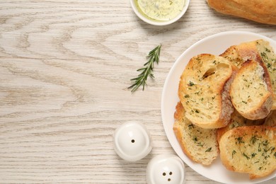 Photo of Tasty baguette with garlic, dill, rosemary and oil on white wooden table, flat lay. Space for text