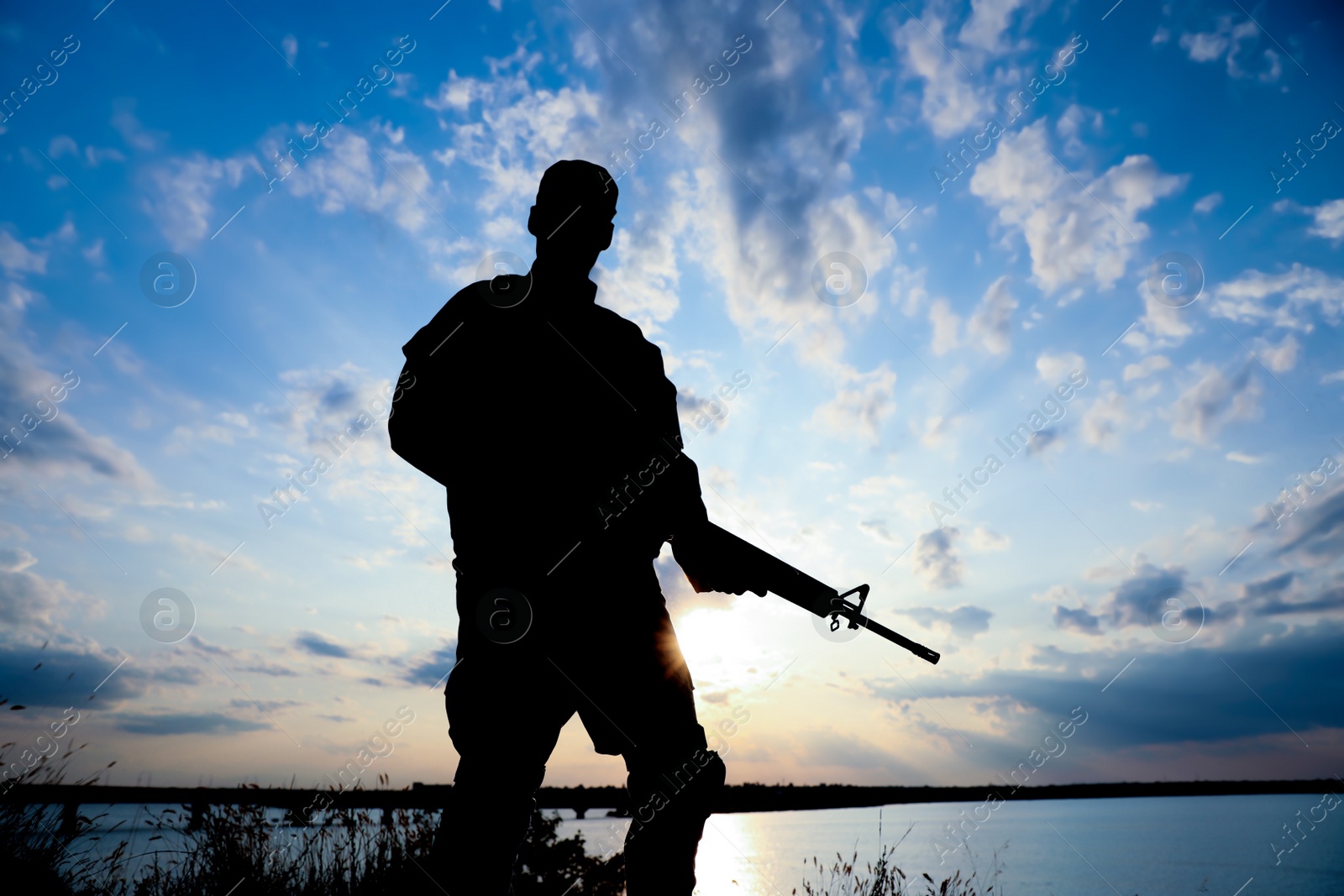 Photo of Soldier with machine gun patrolling outdoors. Military service