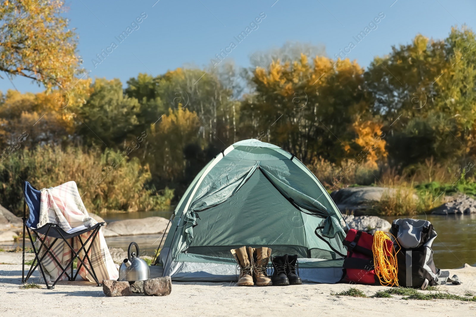 Photo of Set of equipment near camping tent outdoors