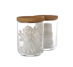 Photo of Cotton pads and swabs in glass jars on white background