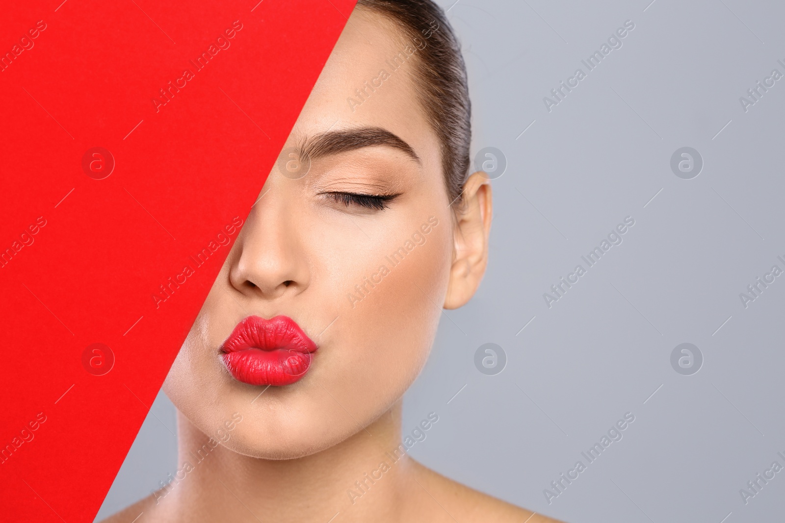 Photo of Young woman wearing beautiful lipstick on color background. Space for text