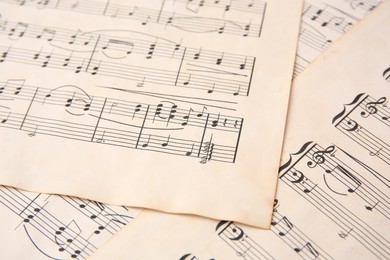 Photo of Sheets of paper with different notes as background, closeup