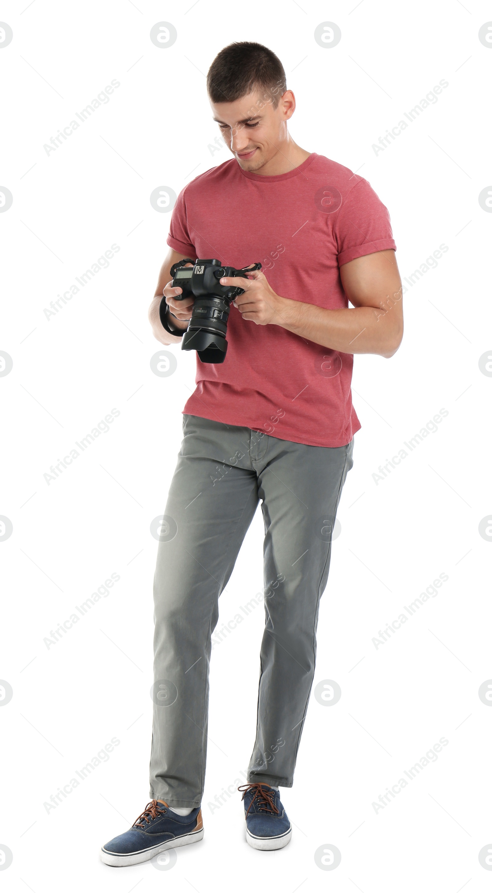 Photo of Young photographer with professional camera on white background