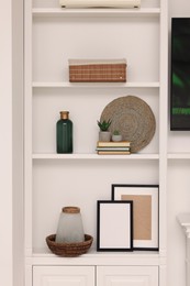 Shelves with different decor indoors. Interior design