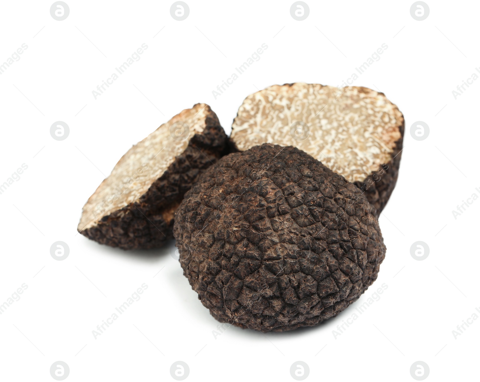 Photo of Cut and whole black truffles isolated on white