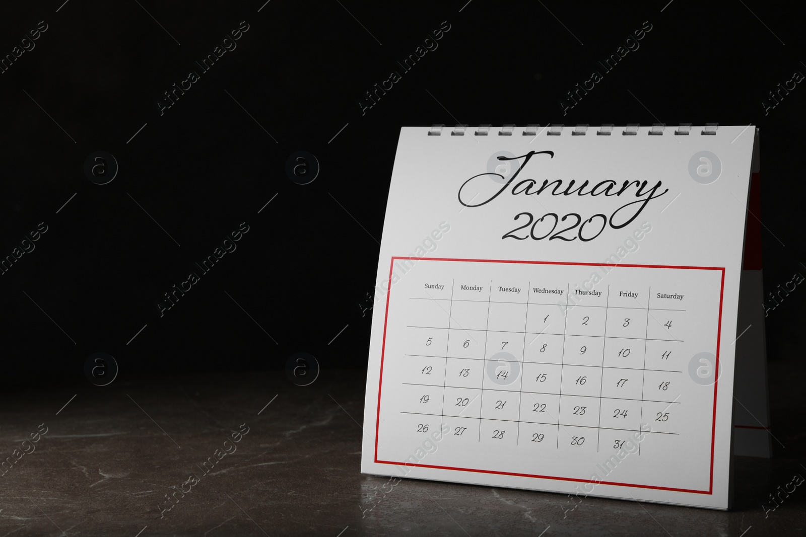 Photo of Paper calendar on stone table, space for text. Planning concept