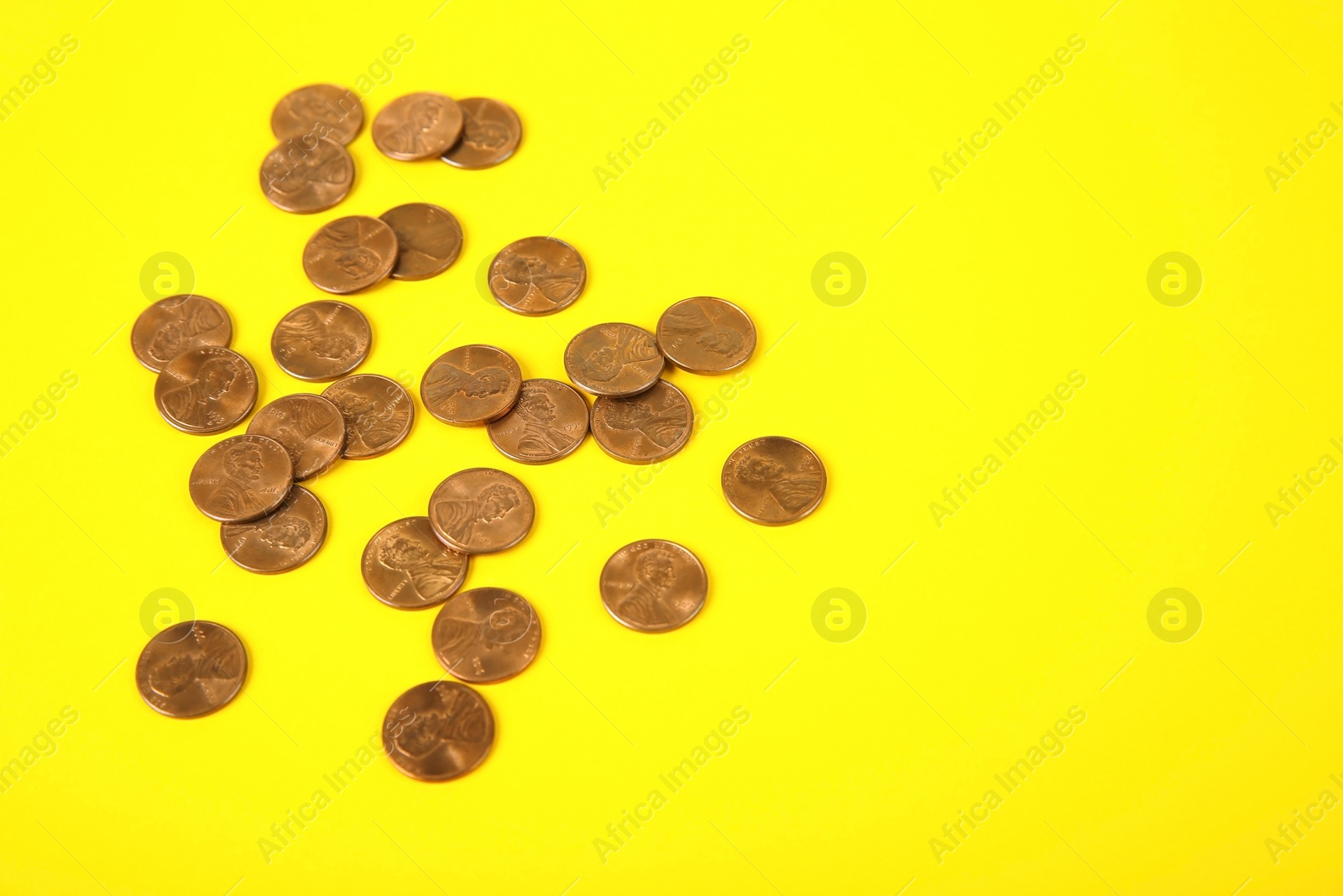 Photo of Many coins on color background, space for text