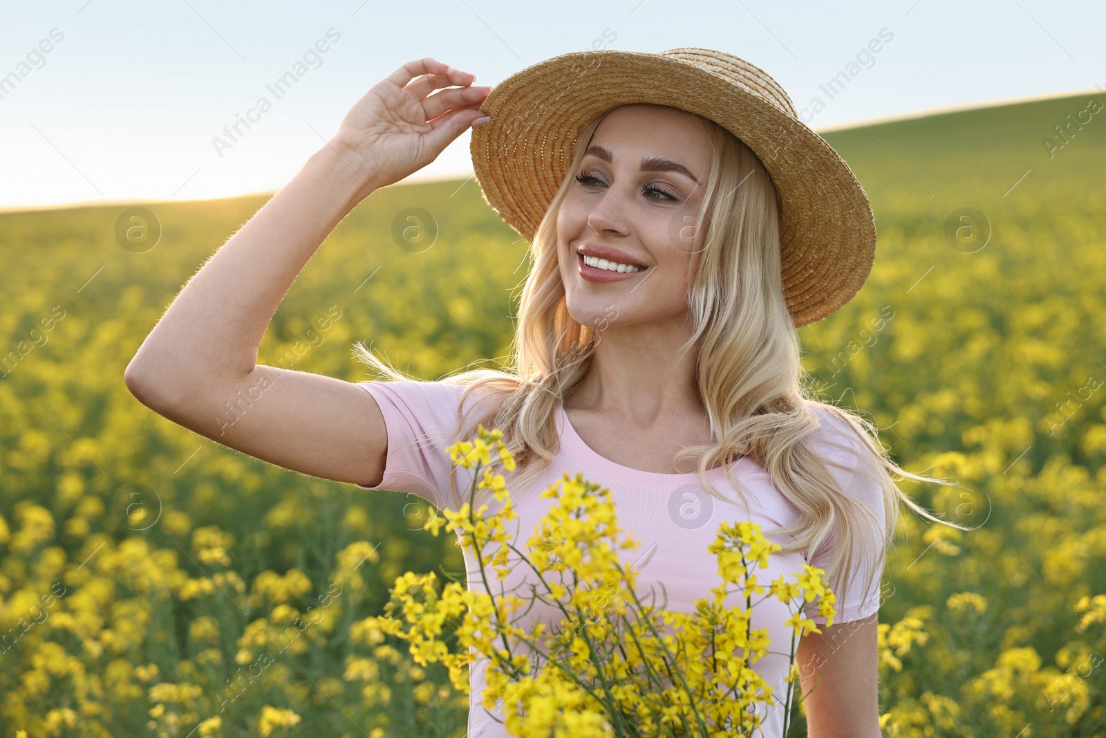 Photo of Portrait of happy young woman in field on spring day