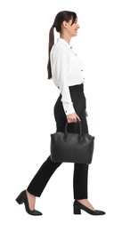 Photo of Happy businesswoman with bag walking on white background