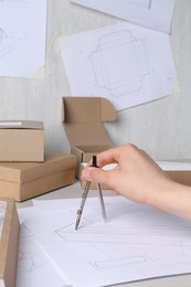 Photo of Man creating packaging design at table, closeup