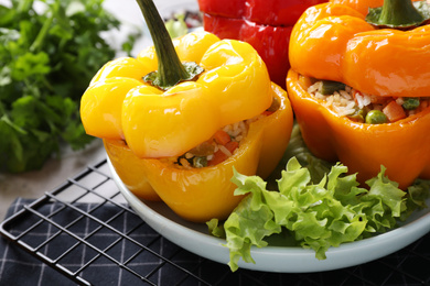 Photo of Tasty stuffed bell peppers on table, closeup