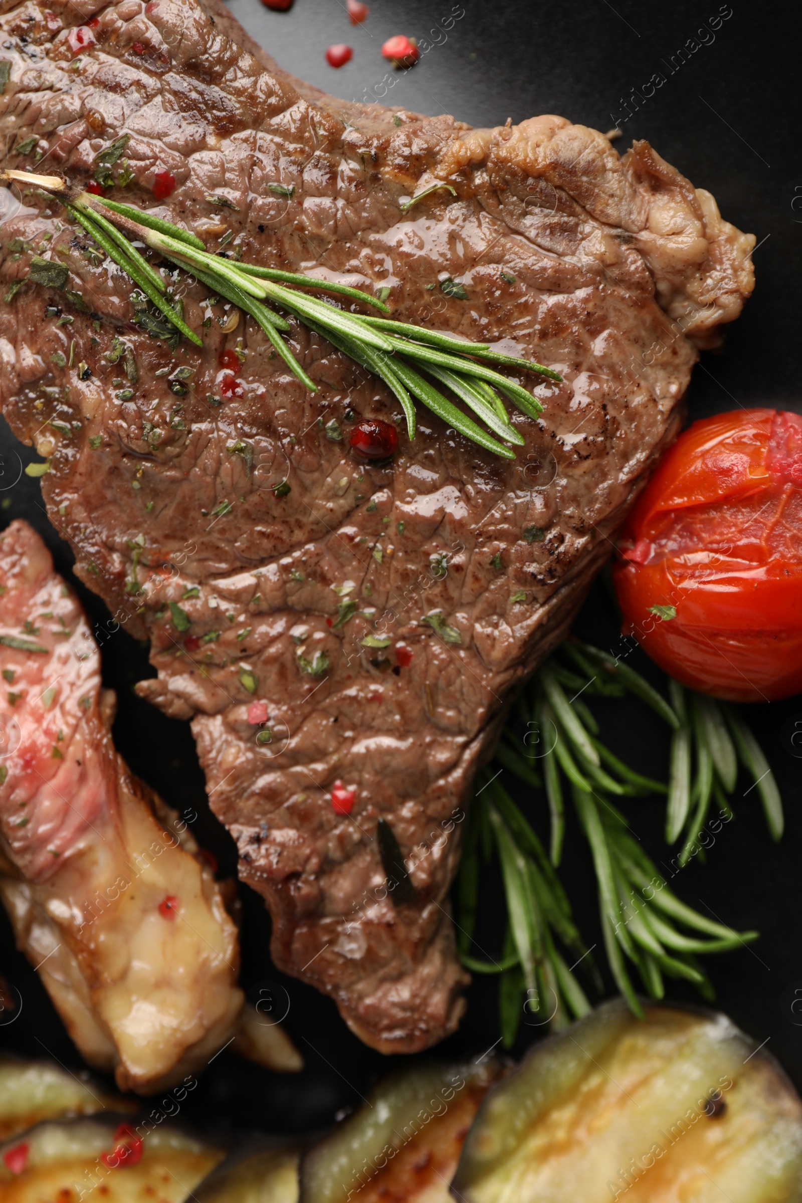 Photo of Delicious grilled beef steak with vegetables and spices on plate, top view