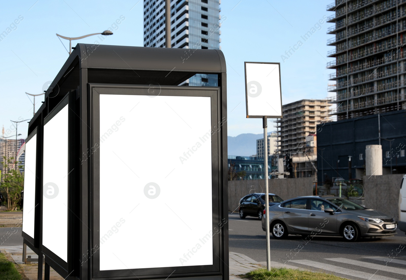 Image of Bus stop with empty signboards in city. Mock-up for design